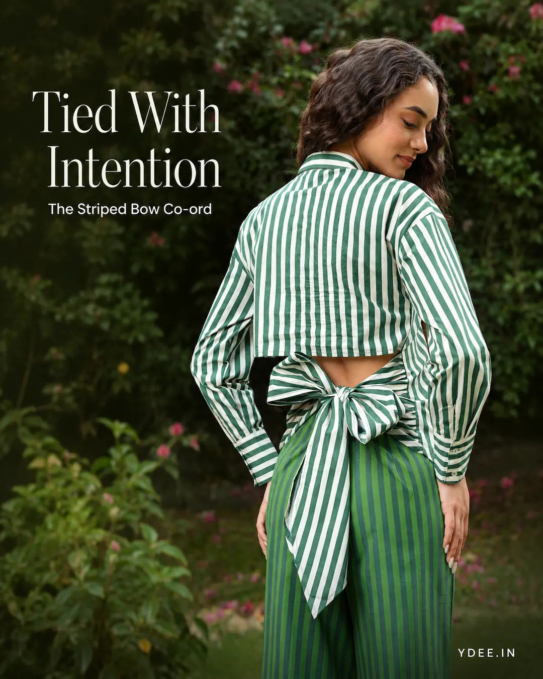 Model in playful reveal orange striped co-ord, garden setting. A Little Reveal, Beautifully Done.